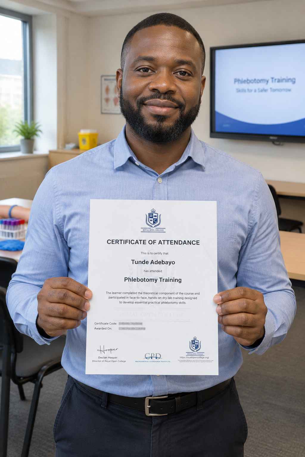 Learner presenting his phlebotomy certificate after training